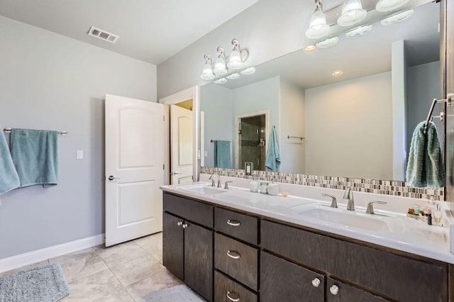 611 Algerita Dr, Georgetown, TX 78628 - full bath featuring double vanity, tile patterned flooring, and decorative backsplash