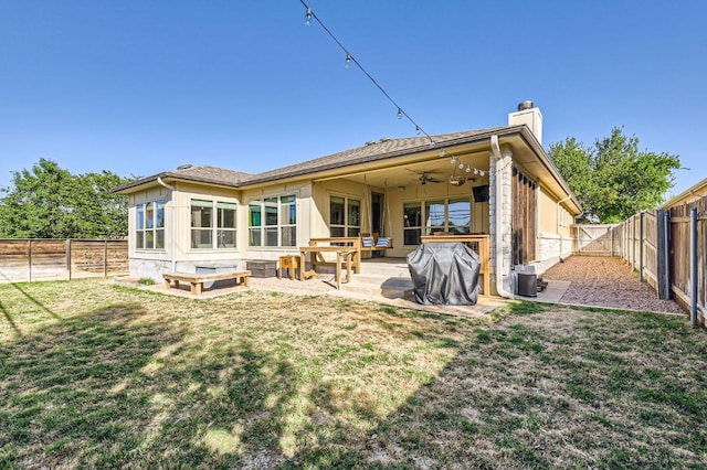 611 Algerita Dr, Georgetown, TX 78628 - rear view of house featuring a chimney, a ceiling fan, a fenced backyard, and a patio area