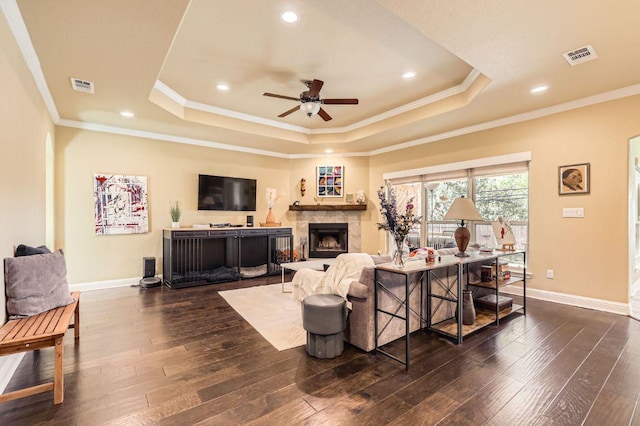 611 Algerita Dr, Georgetown, TX 78628 - living area with a raised ceiling, ceiling fan, dark wood-style floors, a fireplace, and ornamental molding