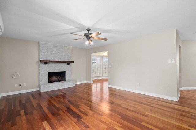 3504 Valley Pike Rd, Cedar Park, TX 78613 - unfurnished living room featuring a ceiling fan, wood finished floors, a large fireplace, and baseboards