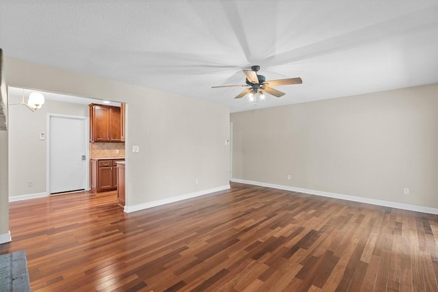3504 Valley Pike Rd, Cedar Park, TX 78613 - unfurnished living room featuring a ceiling fan, dark wood-style flooring, and baseboards