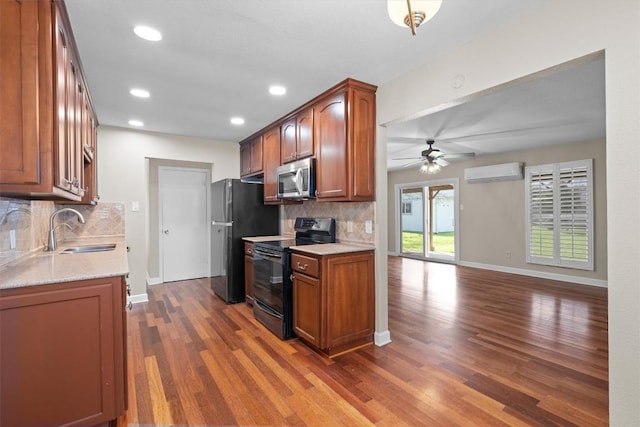 3504 Valley Pike Rd, Cedar Park, TX 78613 - kitchen with black electric range, a sink, stainless steel microwave, a wall unit AC, and a ceiling fan