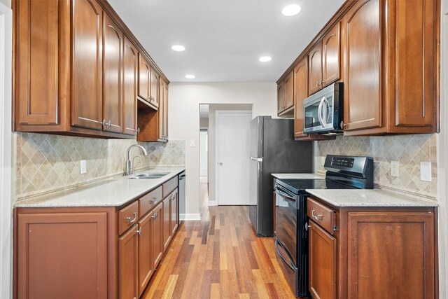 3504 Valley Pike Rd, Cedar Park, TX 78613 - kitchen with appliances with stainless steel finishes, light wood-style flooring, backsplash, recessed lighting, and brown cabinets