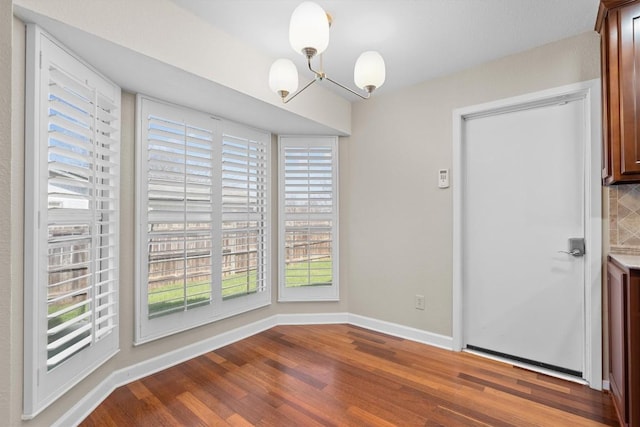 3504 Valley Pike Rd, Cedar Park, TX 78613 - unfurnished dining area with a chandelier, wood finished floors, and baseboards
