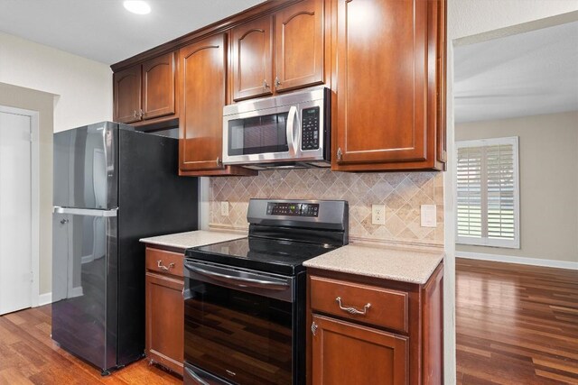 3504 Valley Pike Rd, Cedar Park, TX 78613 - kitchen with electric range, stainless steel microwave, wood finished floors, freestanding refrigerator, and light countertops