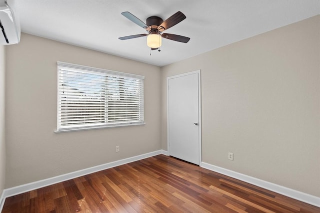 3504 Valley Pike Rd, Cedar Park, TX 78613 - empty room with a wall unit AC, baseboards, wood finished floors, and ceiling fan