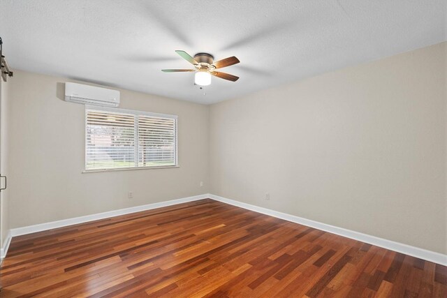3504 Valley Pike Rd, Cedar Park, TX 78613 - spare room with an AC wall unit, wood finished floors, a ceiling fan, and baseboards