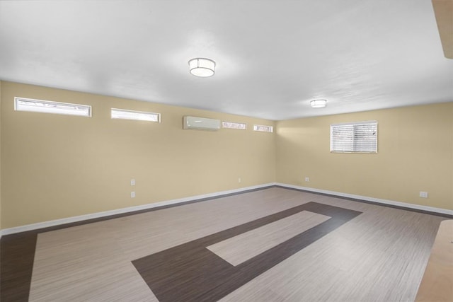 3504 Valley Pike Rd, Cedar Park, TX 78613 - basement featuring baseboards, wood finished floors, and a wall mounted air conditioner