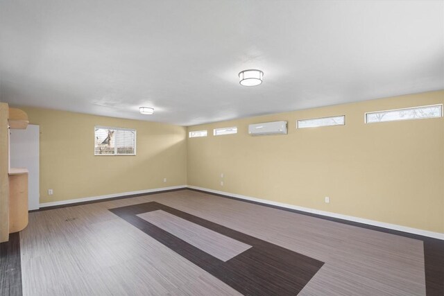 3504 Valley Pike Rd, Cedar Park, TX 78613 - below grade area featuring a wall mounted air conditioner, baseboards, and wood finished floors