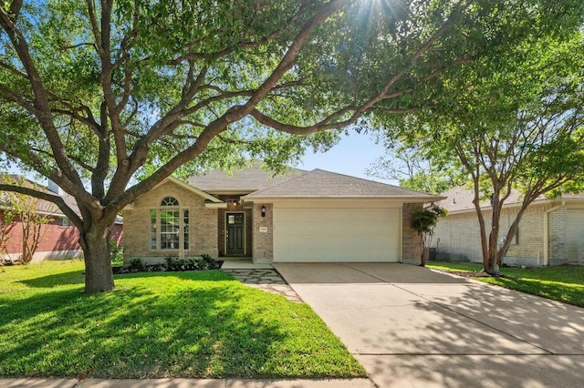 single story home featuring a front yard, driveway, brick siding, and a garage