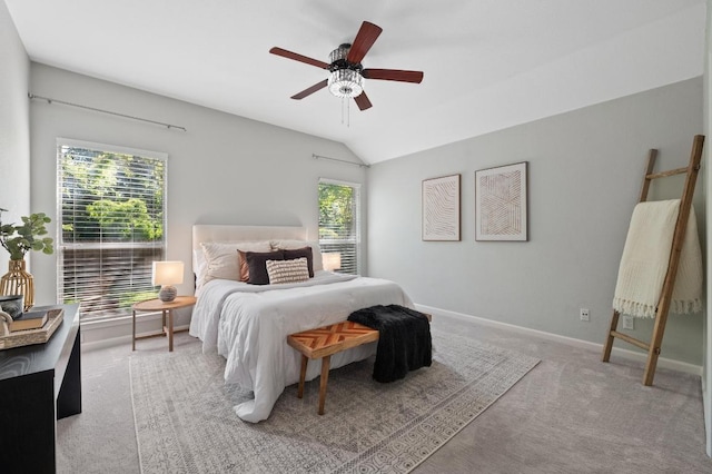 carpeted bedroom with baseboards, ceiling fan, and lofted ceiling