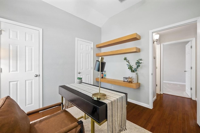 office area featuring wood finished floors, baseboards, and vaulted ceiling