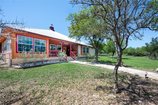 11134 Bonham Ranch Rd, Dripping Springs, TX 78620 - ranch-style house featuring covered porch, a front lawn, metal roof, and a chimney