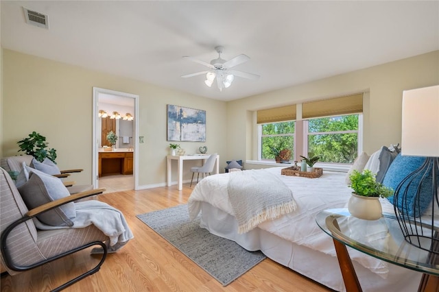 11134 Bonham Ranch Rd, Dripping Springs, TX 78620 - bedroom featuring wood finished floors, ensuite bath, a ceiling fan, and baseboards