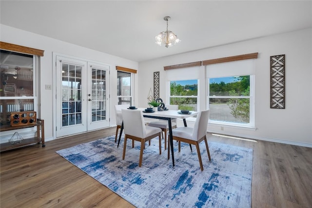 11134 Bonham Ranch Rd, Dripping Springs, TX 78620 - dining area featuring french doors, a chandelier, wood finished floors, and baseboards