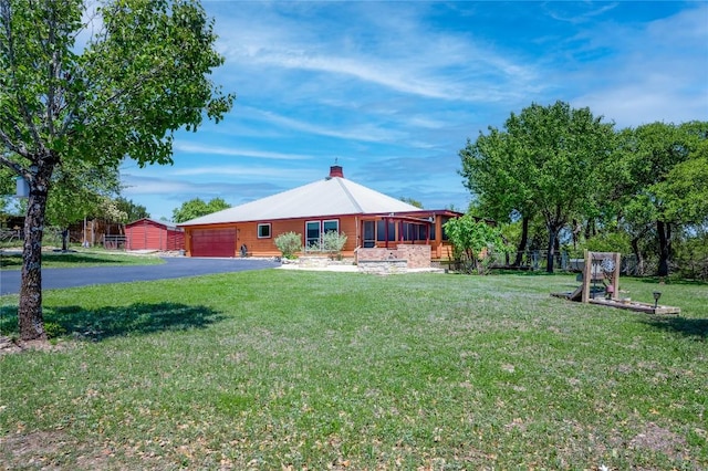 11134 Bonham Ranch Rd, Dripping Springs, TX 78620 - back of house with a garage, asphalt driveway, and a yard