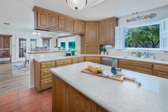 11134 Bonham Ranch Rd, Dripping Springs, TX 78620 - kitchen featuring a sink, stainless steel dishwasher, french doors, a peninsula, and light tile patterned floors