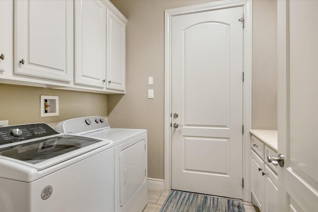 laundry area featuring washer and clothes dryer, cabinet space, and baseboards