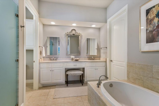 bathroom with tile patterned floors, double vanity, a bath, and a sink