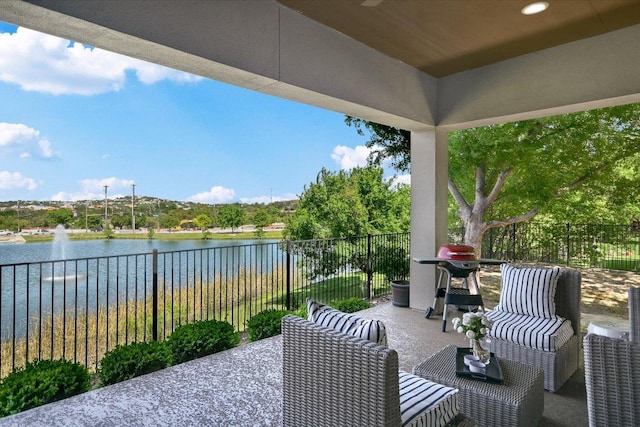 view of patio featuring a water view and an outdoor living space