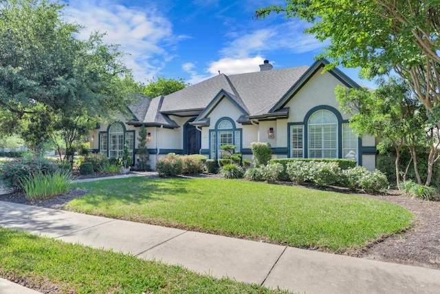 1505 Lake Forest Cv, Round Rock, TX 78665 - view of front of house with stucco siding, a front yard, and a chimney