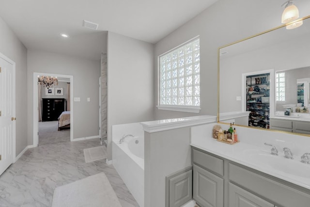 1505 Lake Forest Cv, Round Rock, TX 78665 - ensuite bathroom with marble look tiles, vanity, a bath, a chandelier, and recessed lighting