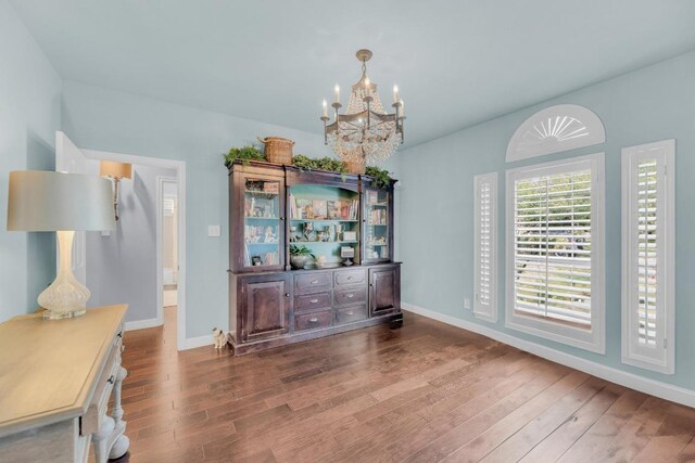 1505 Lake Forest Cv, Round Rock, TX 78665 - dining space featuring a chandelier, wood finished floors, and baseboards