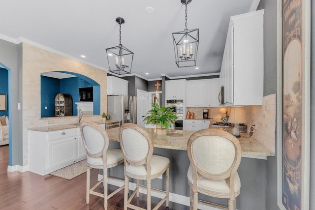 1505 Lake Forest Cv, Round Rock, TX 78665 - kitchen featuring stainless steel appliances, recessed lighting, a chandelier, backsplash, and wood finished floors