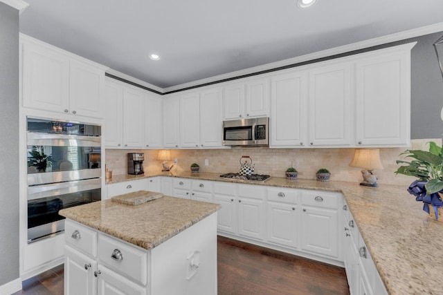 1505 Lake Forest Cv, Round Rock, TX 78665 - kitchen featuring appliances with stainless steel finishes, tasteful backsplash, dark wood-style floors, white cabinetry, and recessed lighting