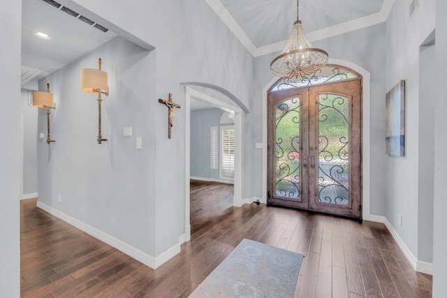 1505 Lake Forest Cv, Round Rock, TX 78665 - foyer featuring a chandelier, french doors, arched walkways, wood-type flooring, and crown molding
