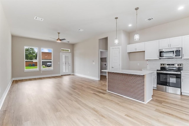 650 Aspen Ln, Cottonwood Shores, TX 78657 - kitchen with stainless steel appliances, ceiling fan, backsplash, and white cabinets