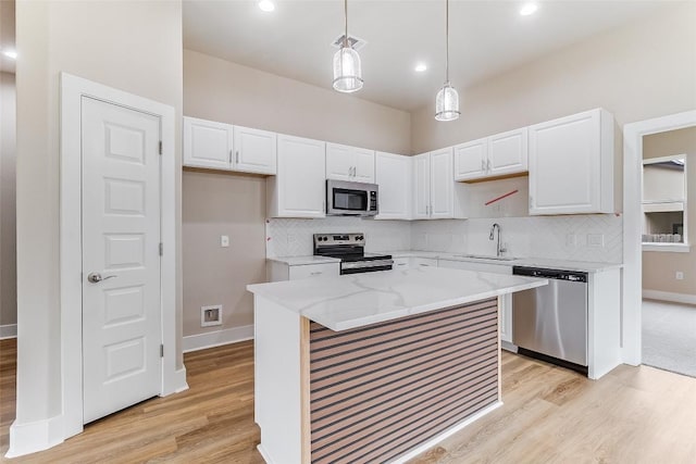 650 Aspen Ln, Cottonwood Shores, TX 78657 - kitchen featuring stainless steel appliances, light wood finished floors, white cabinetry, backsplash, and recessed lighting