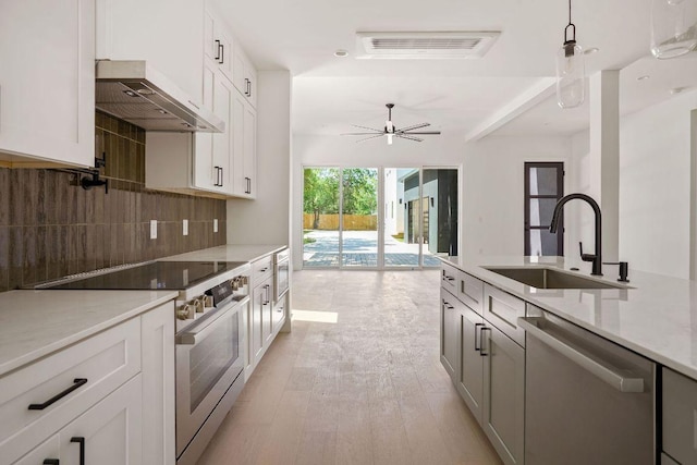 kitchen with tasteful backsplash, visible vents, hanging light fixtures, a sink, and appliances with stainless steel finishes