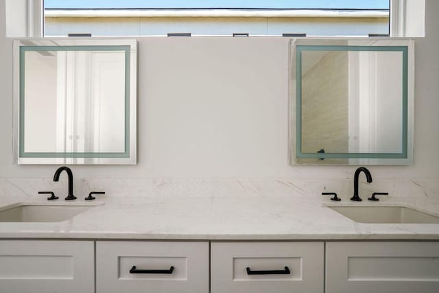full bath featuring double vanity and a sink