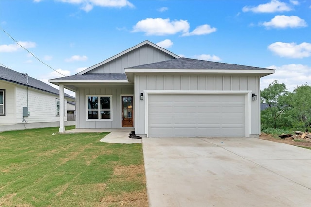 652 Aspen Ln, Cottonwood Shores, TX 78657 - view of front facade with board and batten siding, roof with shingles, a front lawn, driveway, and a garage