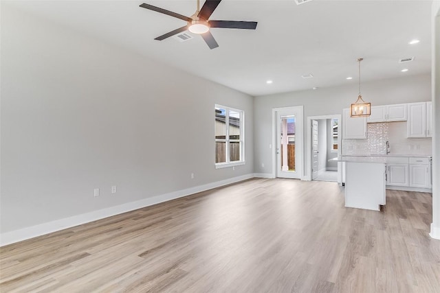 652 Aspen Ln, Cottonwood Shores, TX 78657 - unfurnished living room featuring a ceiling fan, recessed lighting, and light wood-type flooring