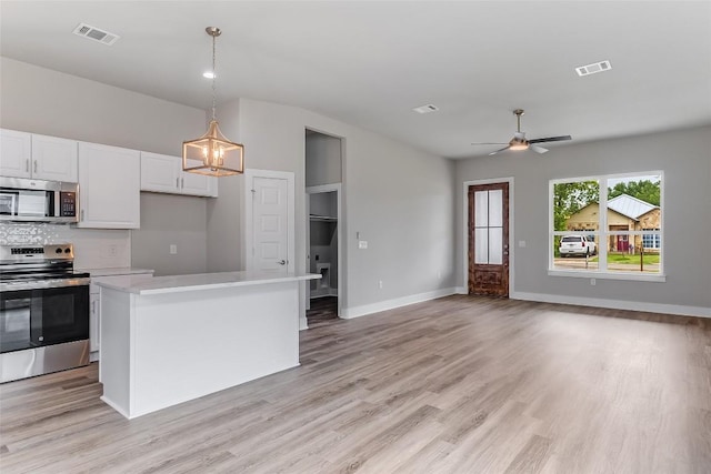 652 Aspen Ln, Cottonwood Shores, TX 78657 - kitchen featuring stainless steel appliances, a chandelier, light countertops, white cabinetry, and light wood finished floors