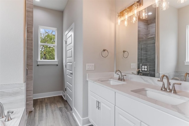652 Aspen Ln, Cottonwood Shores, TX 78657 - full bathroom with double vanity and wood finished floors