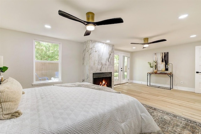6007 Belfast Dr, Austin, TX 78723 - bedroom with light wood-type flooring, access to outside, a high end fireplace, recessed lighting, and ceiling fan