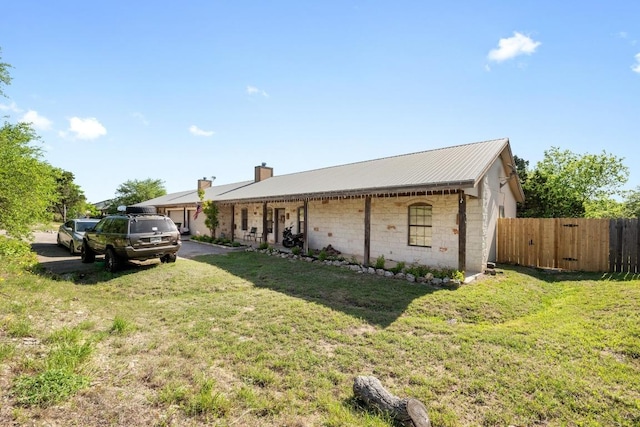 201 Loving Trl, Dripping Springs, TX 78620 - view of front of house featuring metal roof and a chimney
