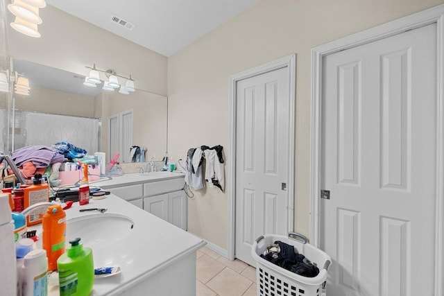 201 Loving Trl, Dripping Springs, TX 78620 - full bath with tile patterned floors, vanity, and baseboards
