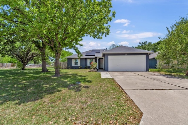 ranch-style house featuring a garage, solar panels, concrete driveway, and stucco siding