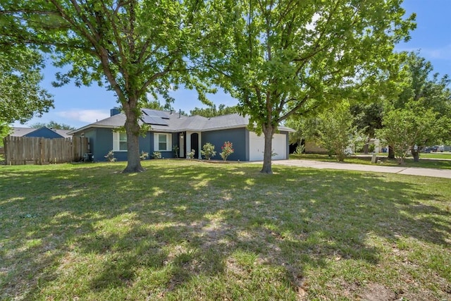 206 Quail Cir, Hutto, TX 78634 - ranch-style house featuring concrete driveway, a garage, and roof mounted solar panels