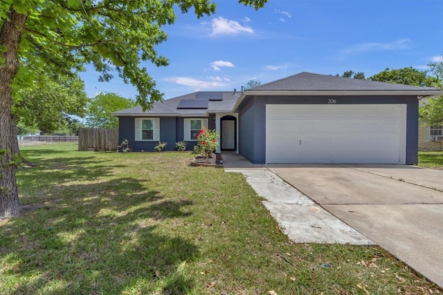 ranch-style home with solar panels, an attached garage, concrete driveway, and stucco siding