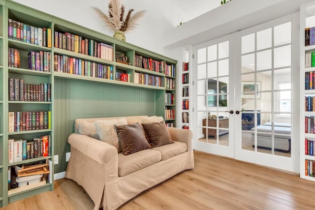 living area with wood finished floors and french doors