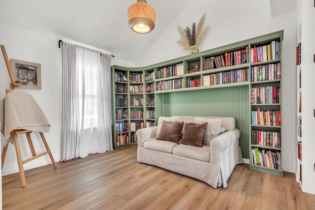 sitting room with wood finished floors and vaulted ceiling