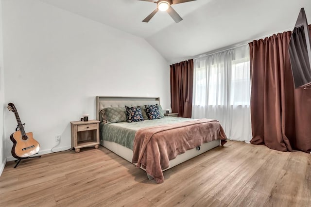 206 Quail Cir, Hutto, TX 78634 - bedroom with light wood-style flooring, vaulted ceiling, a ceiling fan, and baseboards