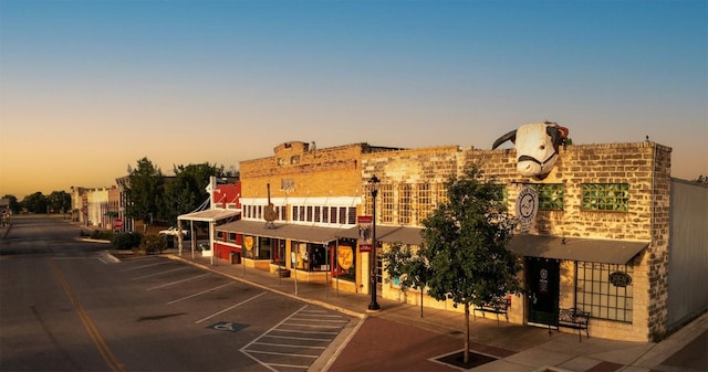 property at dusk featuring uncovered parking
