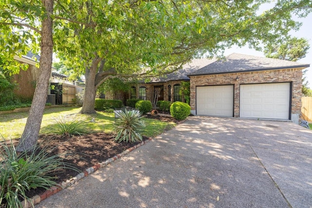 7303 Bluntleaf Cv, Austin, TX 78750 - view of front of home featuring concrete driveway, a garage, brick siding, and roof with shingles