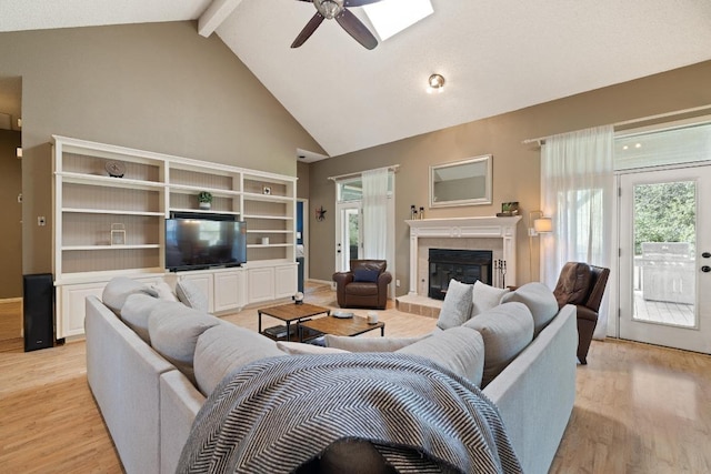 7303 Bluntleaf Cv, Austin, TX 78750 - living area featuring a ceiling fan, beam ceiling, healthy amount of natural light, high vaulted ceiling, and light wood-type flooring